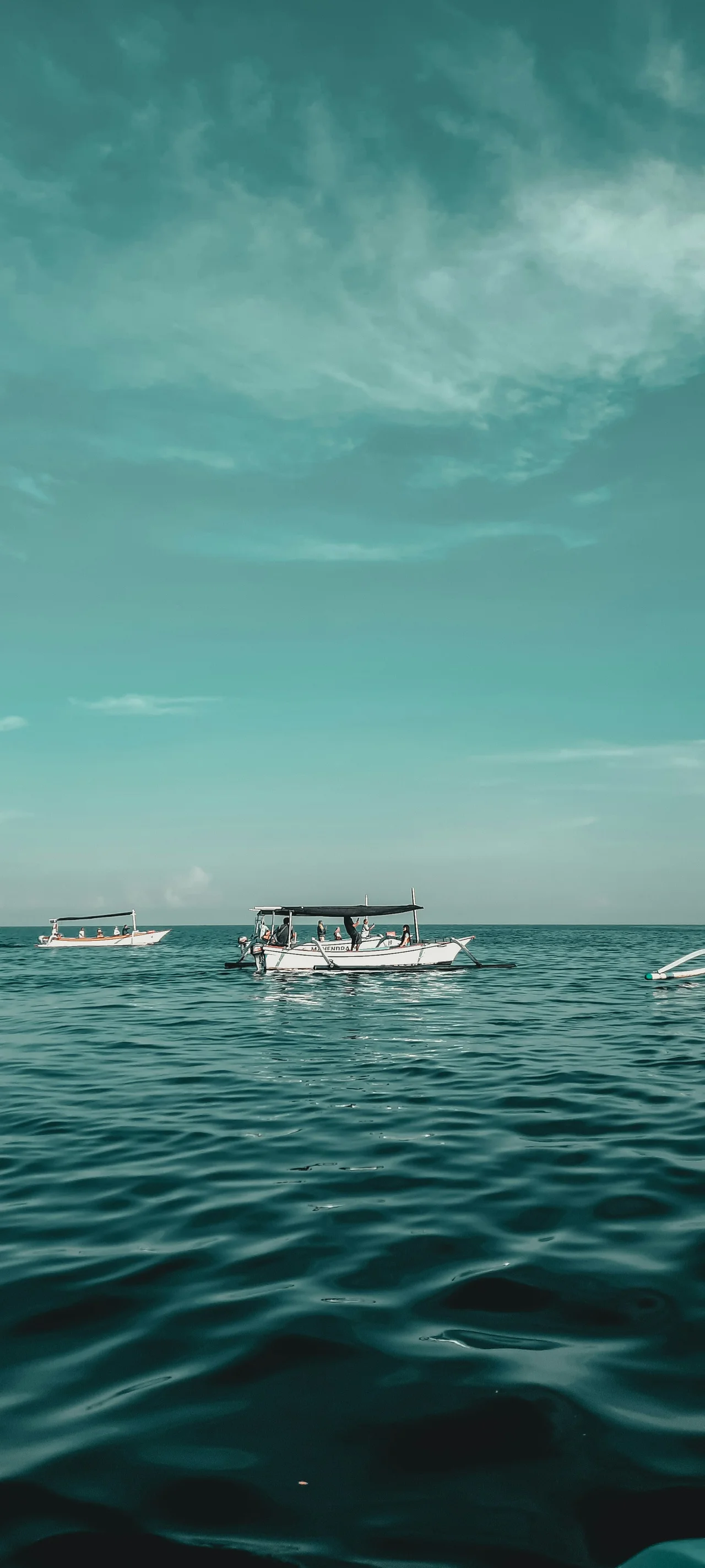 Traditional boats on turquoise water off Lovina, Bali